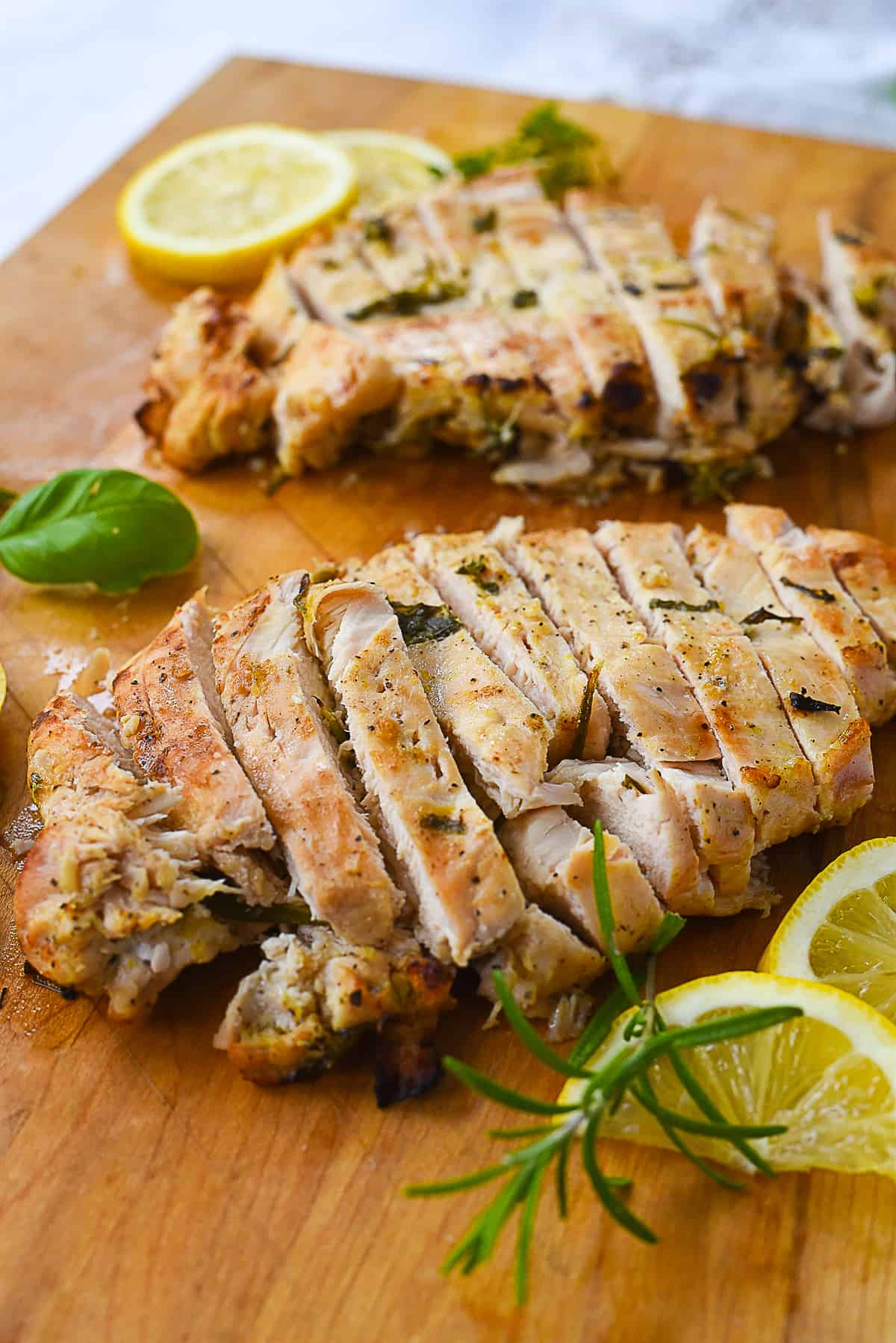 Two sliced chicken breasts on a cutting board