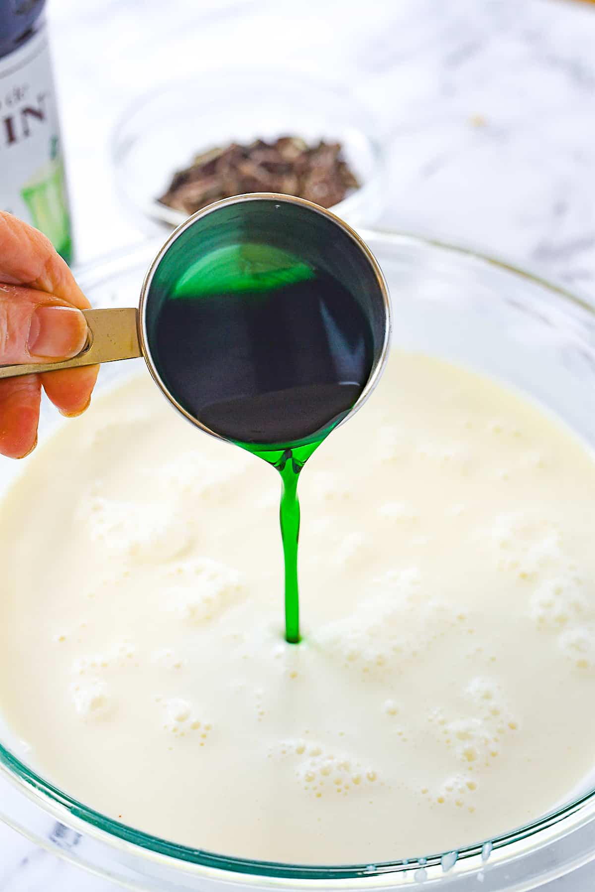 adding mint syrup to ice cream base