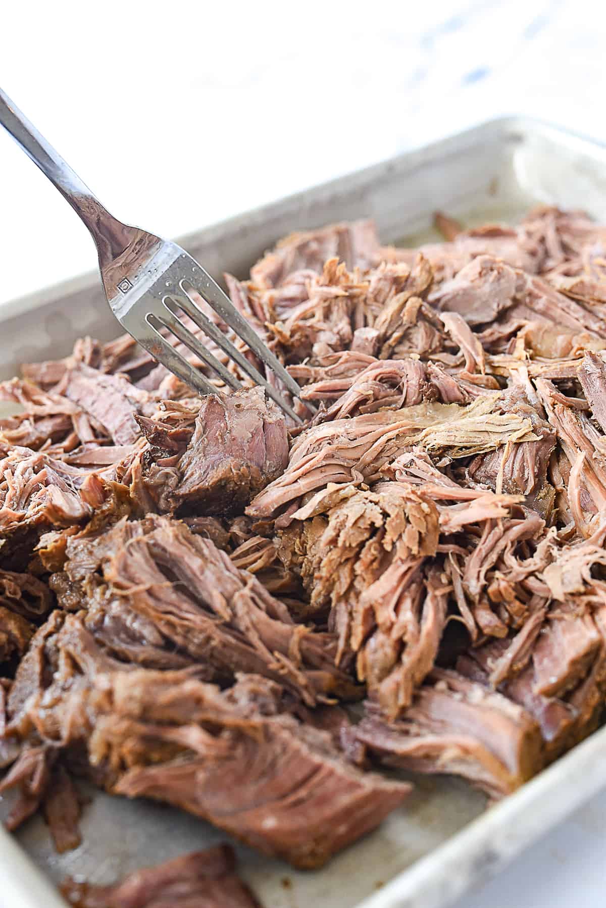 shredding beef with a fork