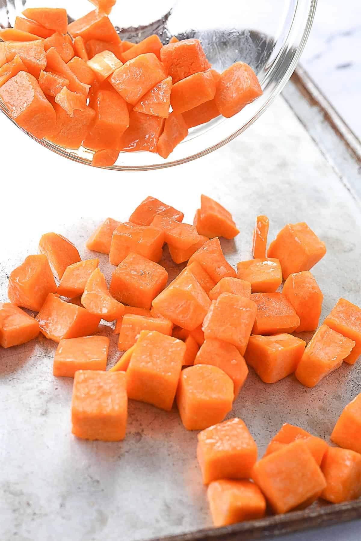 pouring squash onto baking sheet