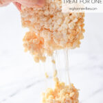 hand pulling apart a rice krispie treat