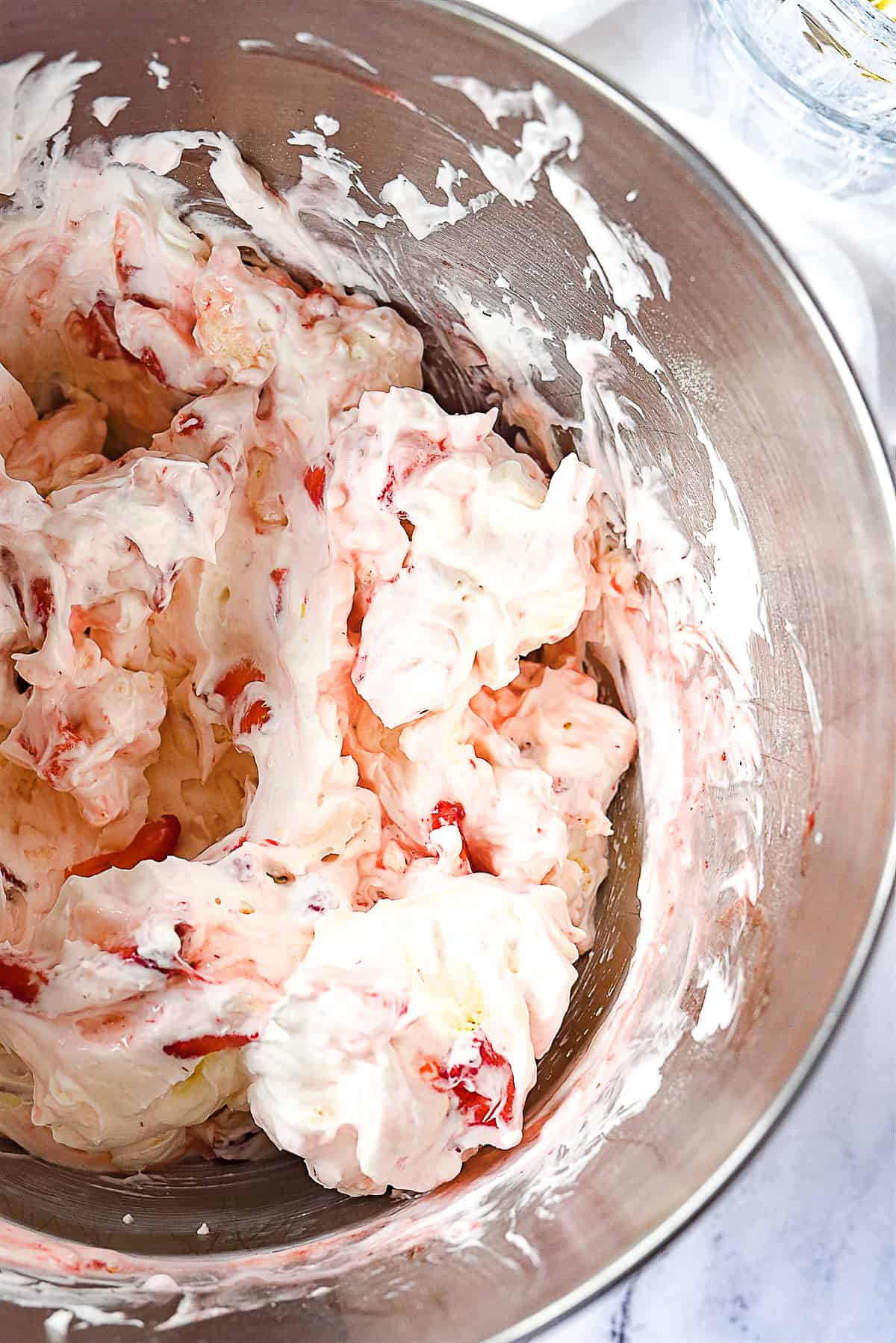 folding strawberries into eton mess