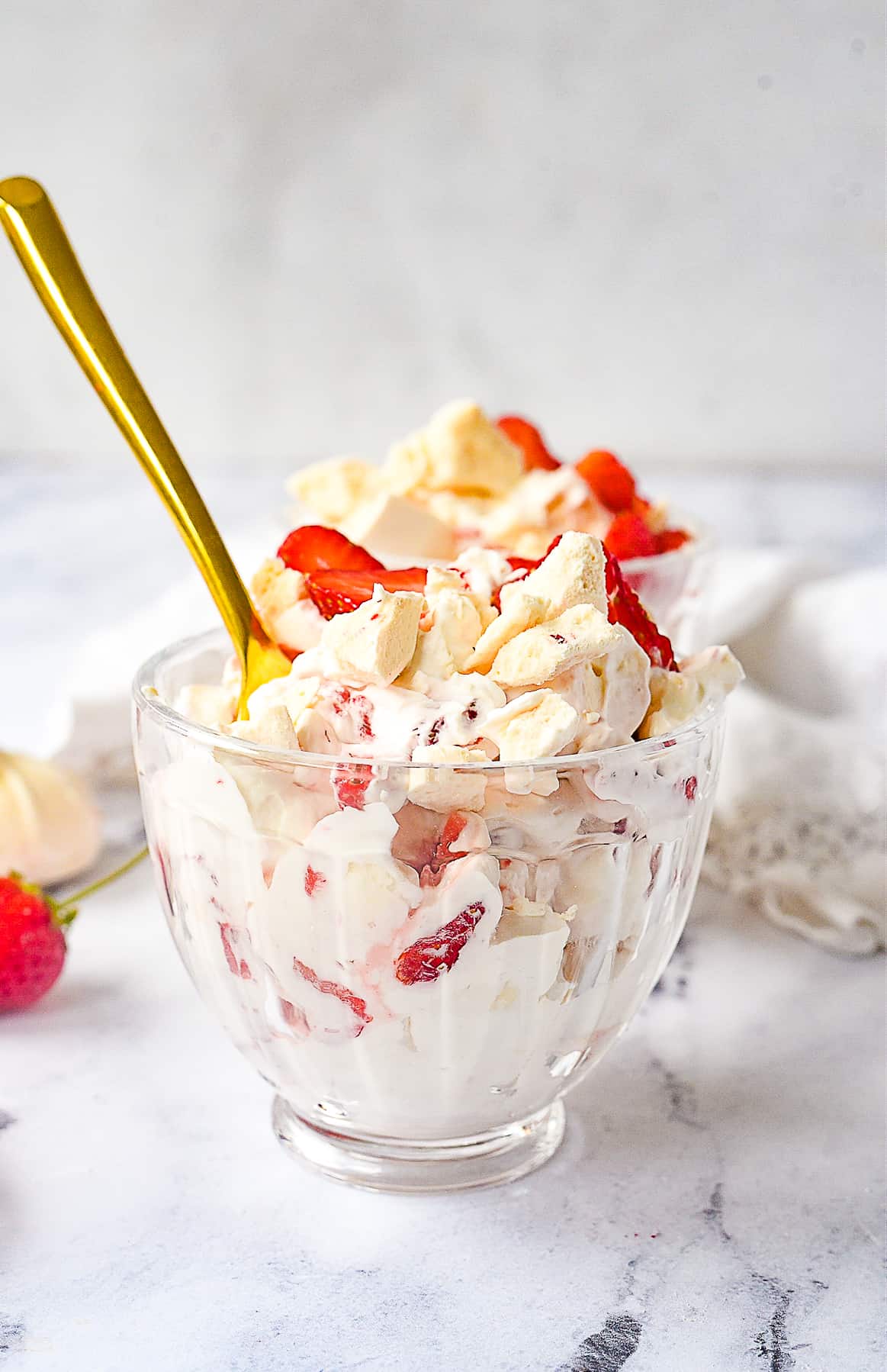 BOWL OF EATON MESS WITH A SPOON IN IT.