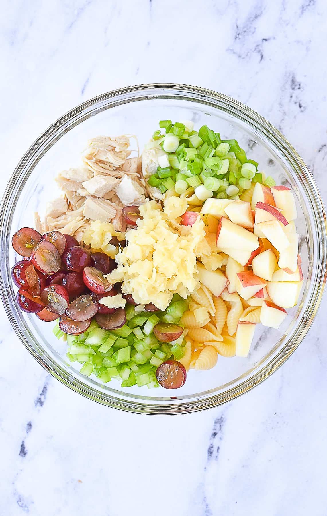 chicken salad with pasta ingredients in a bowl