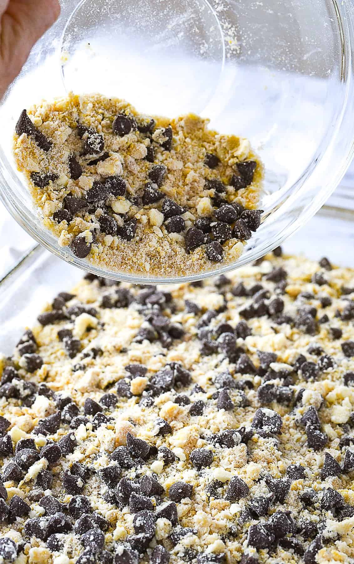 pouring crumb mixture over crust