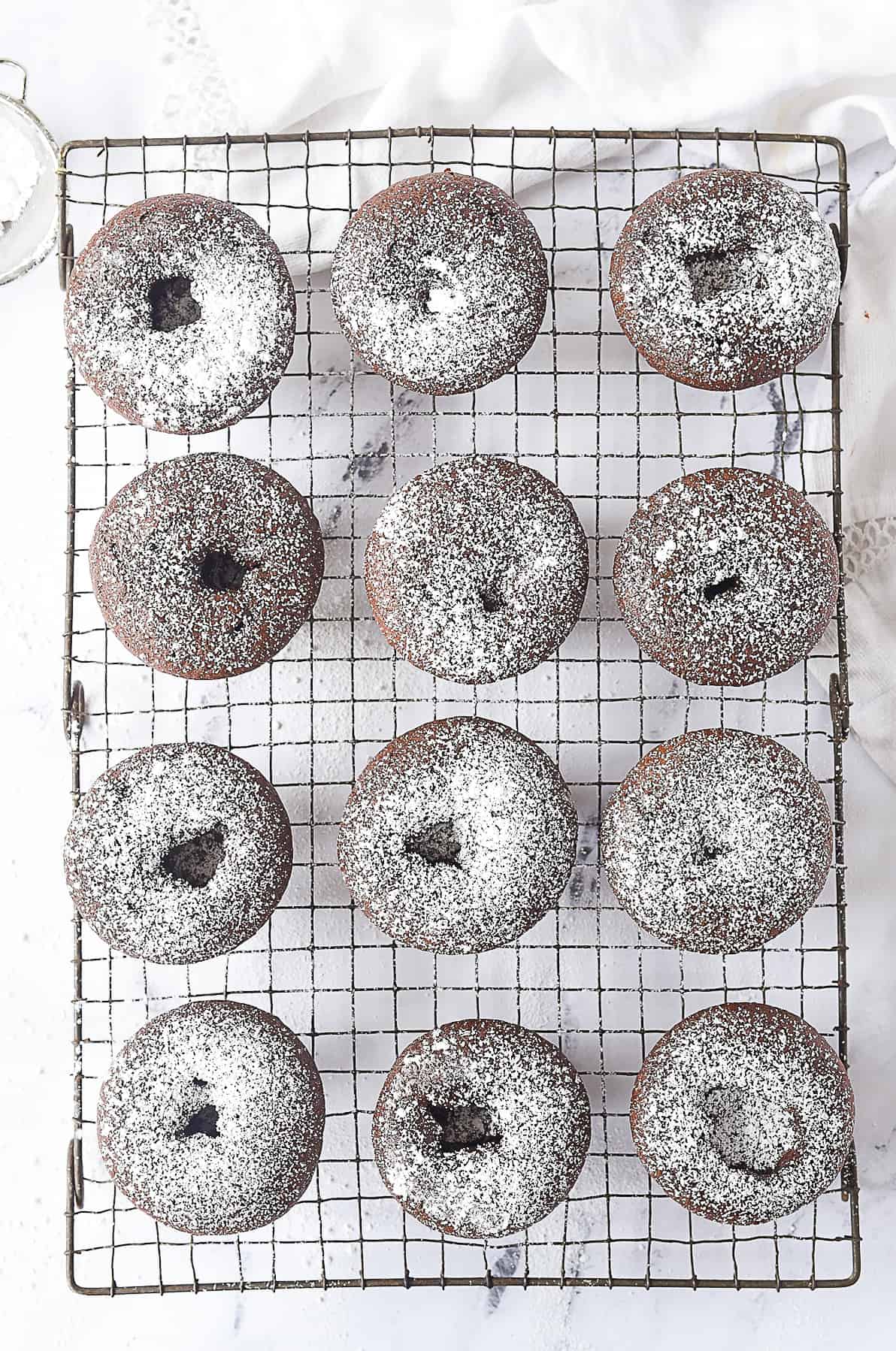 overhead shot of chocolate cupcakes with powdered sugar on them