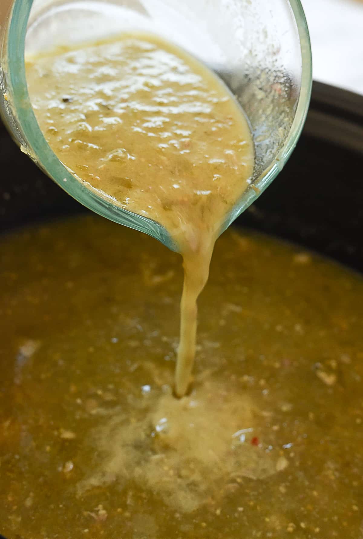 pouring cornstarch mixture into crock pot