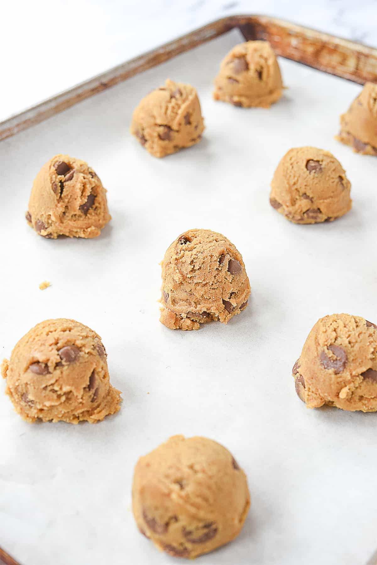 balls of dough on a baking sheet