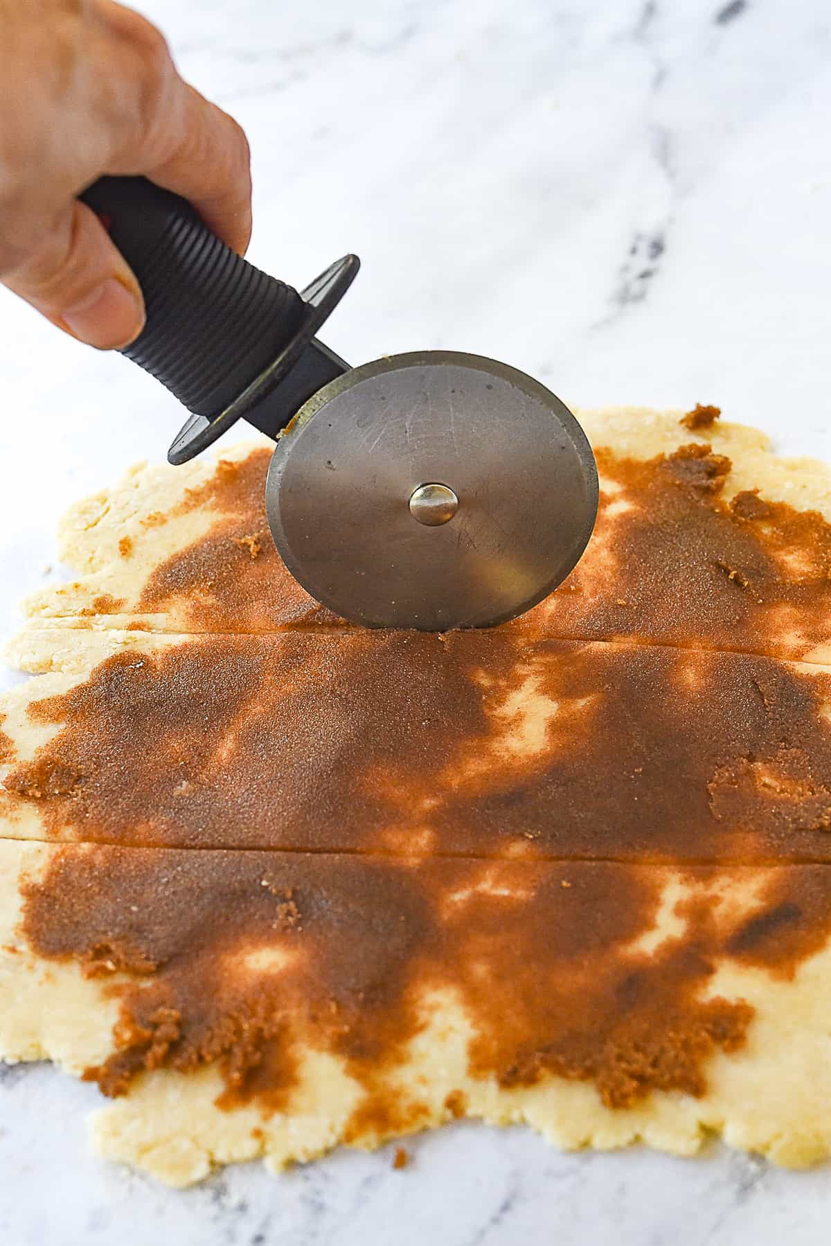 cutting cinnamon roll dough