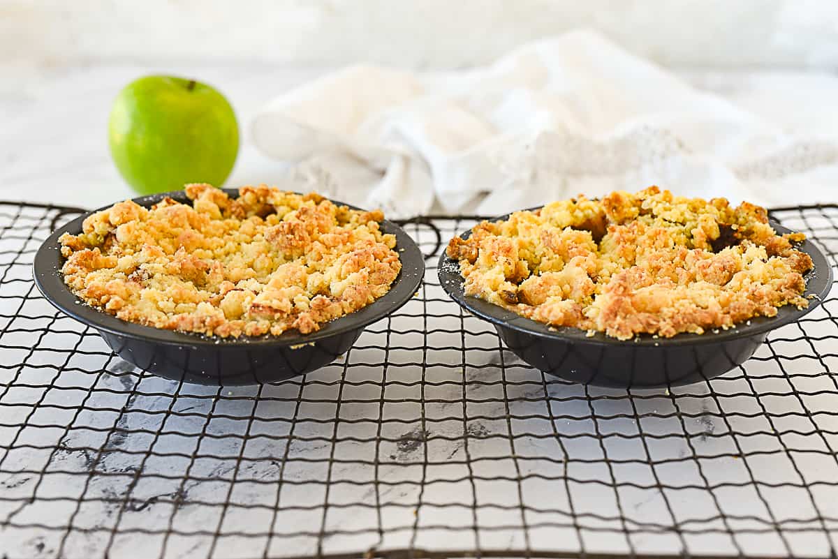 two mini apples pies on cooling rack