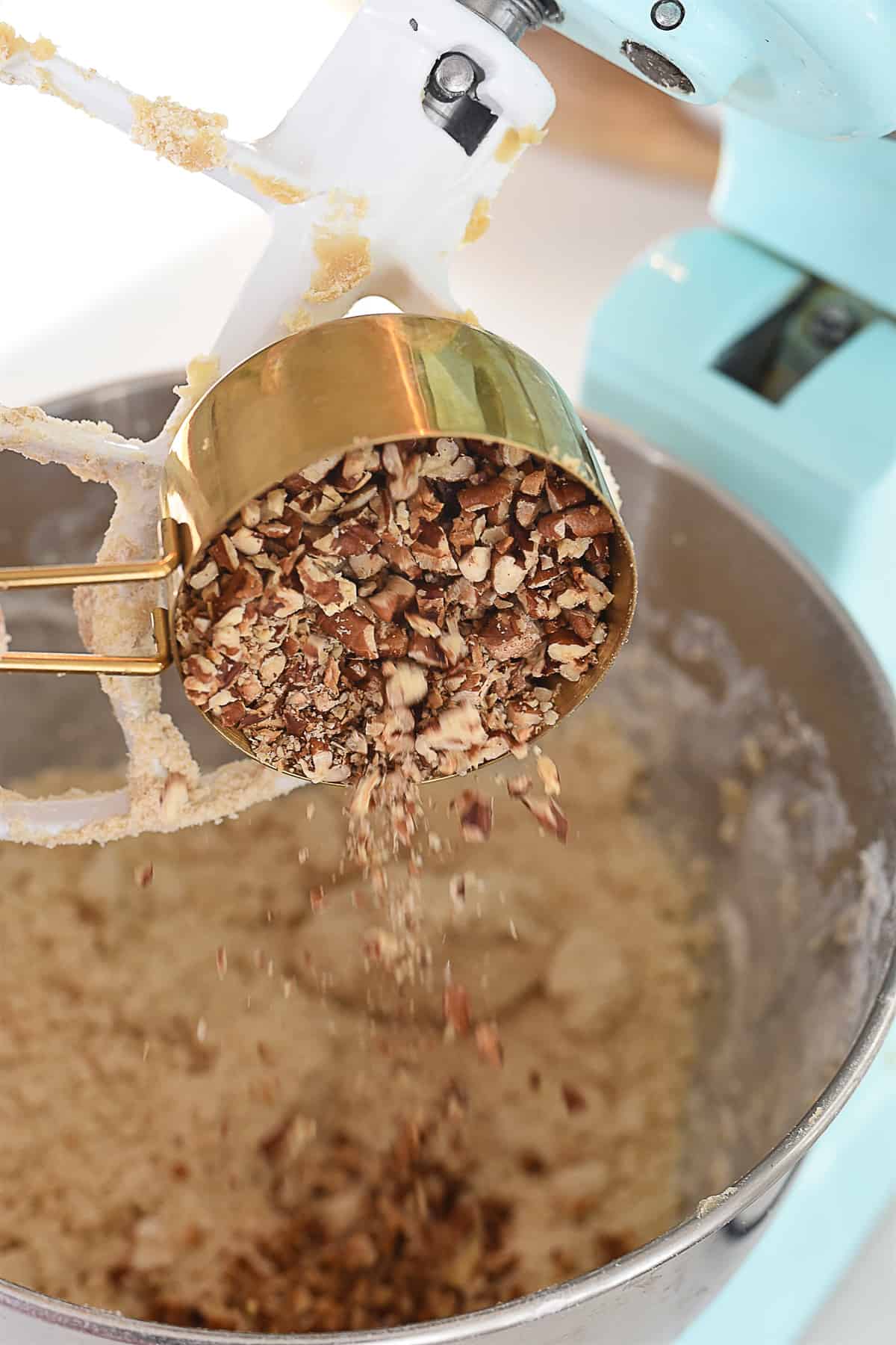 adding pecans to cookie dough