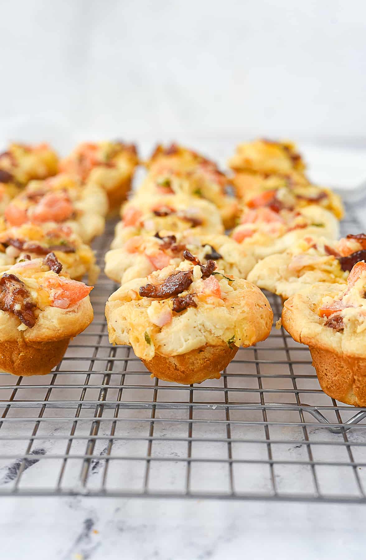 close up of tomato bacon cups on a cooling rack