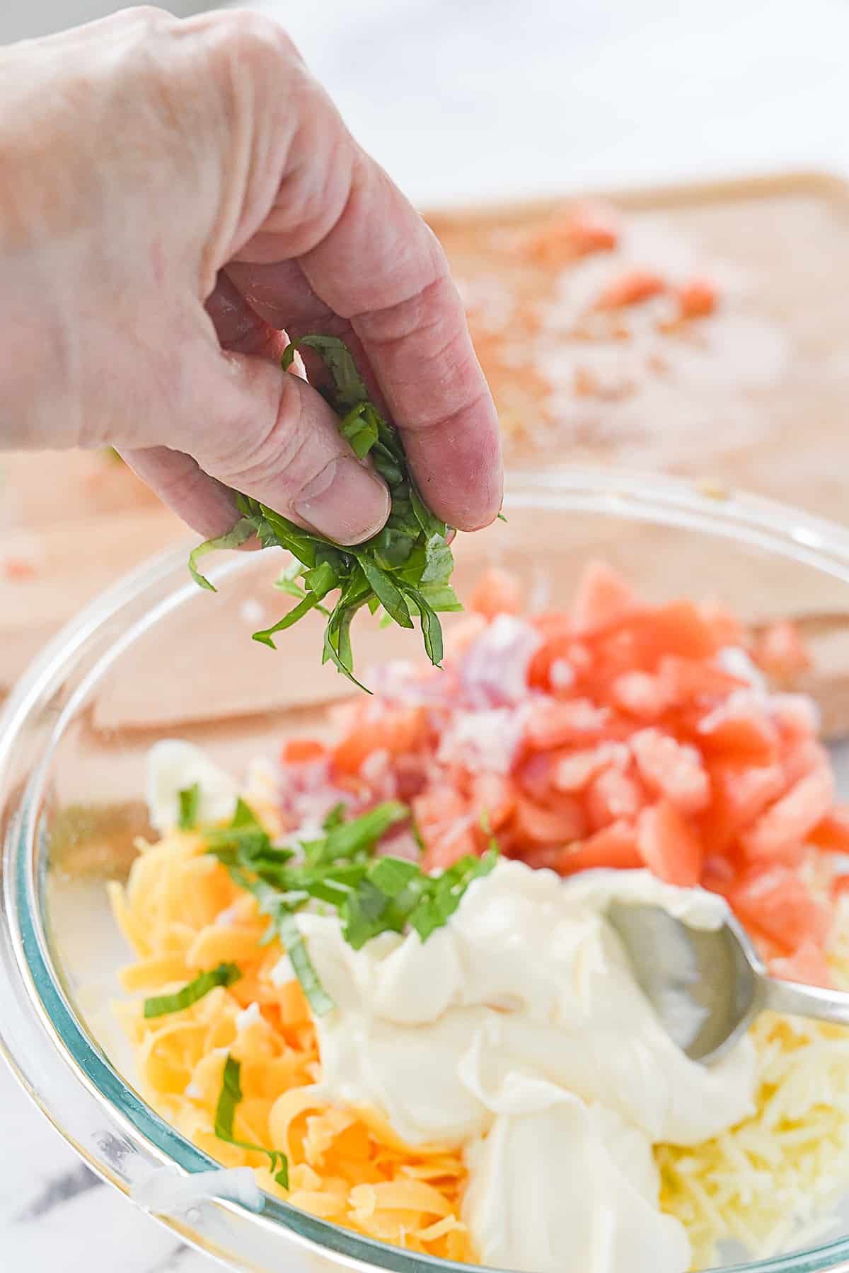 adding basil to mixture