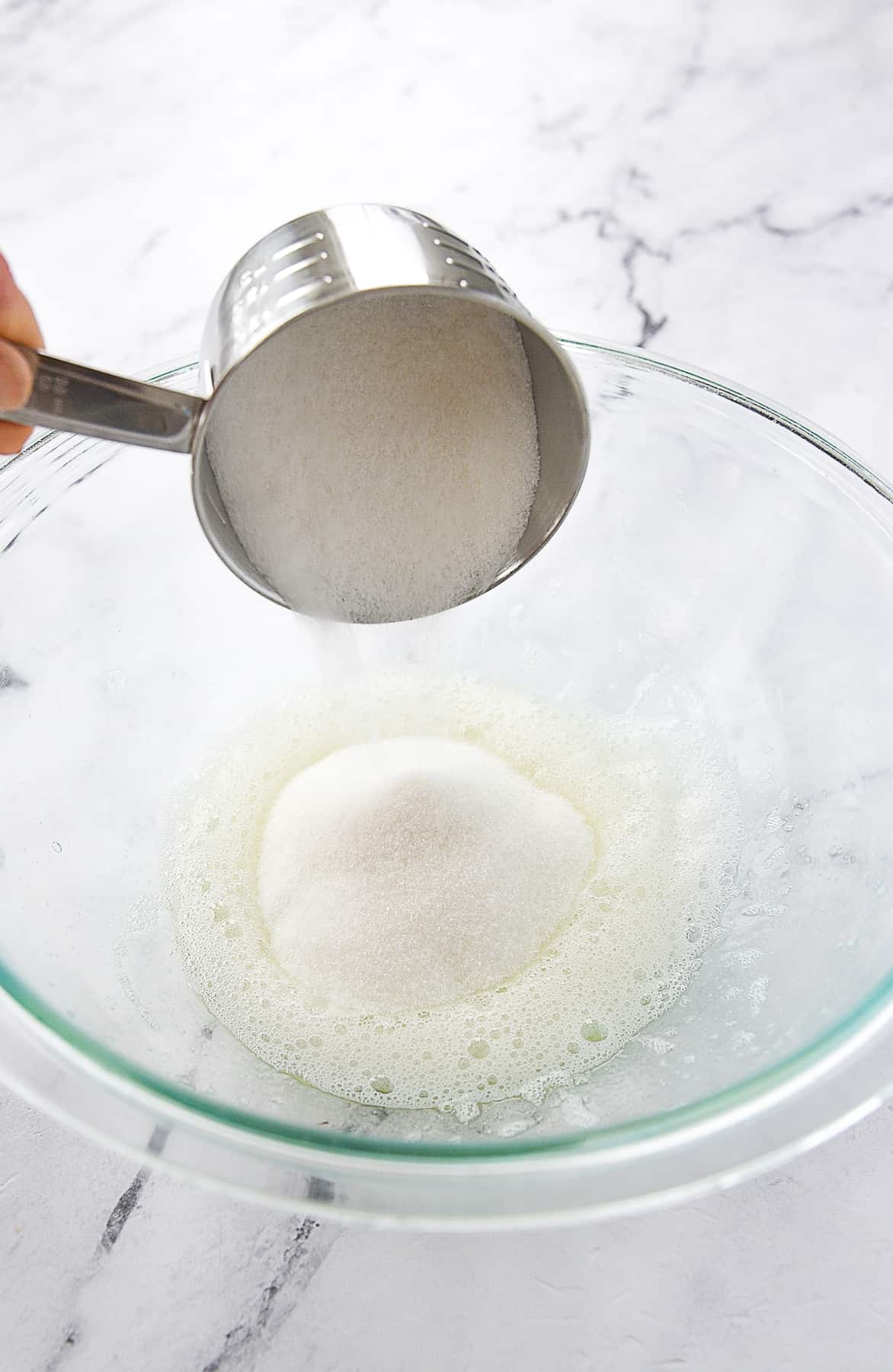 adding sugar to beaten egg whites