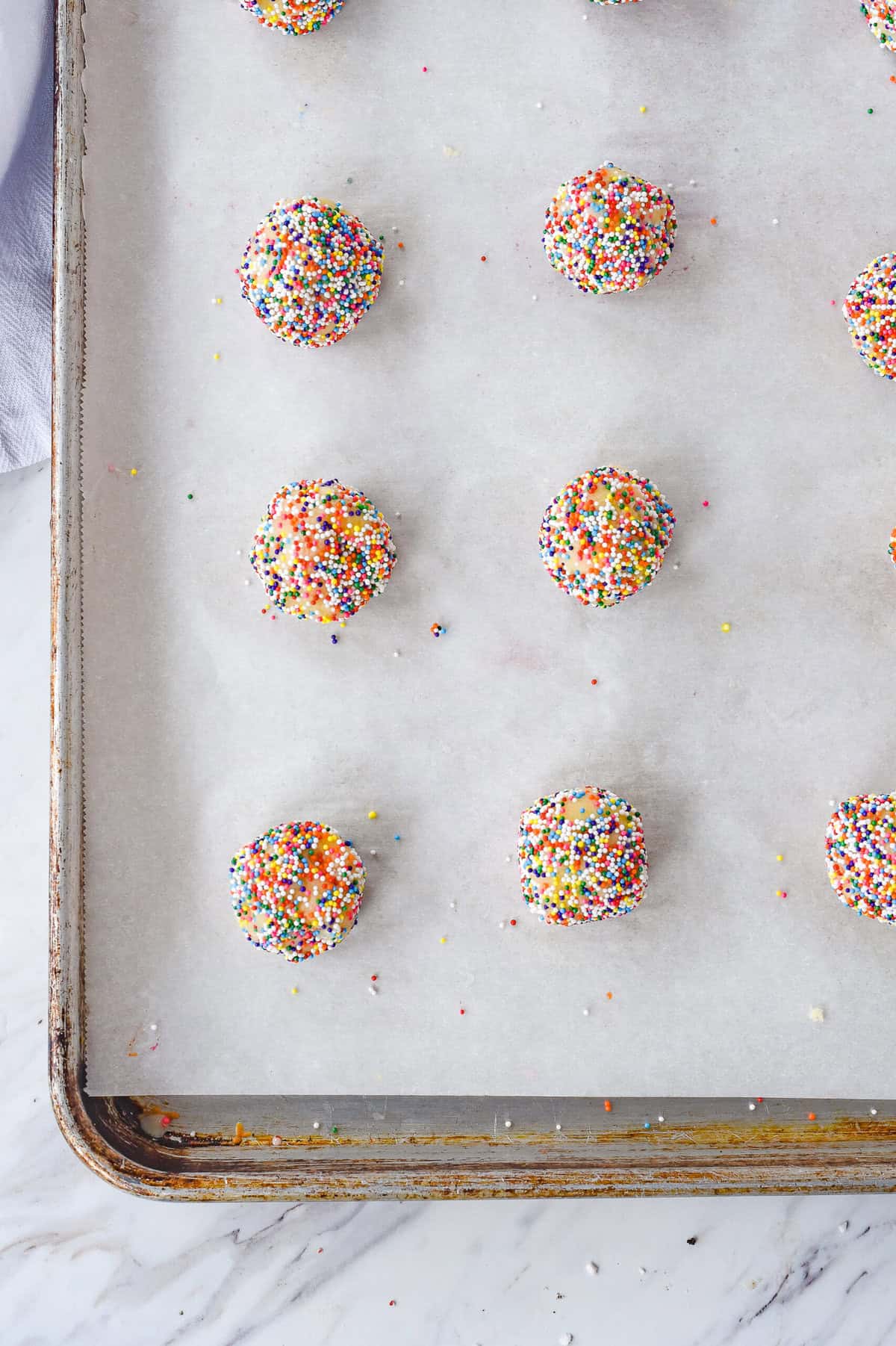 cookie dough balls on a cookie sheet