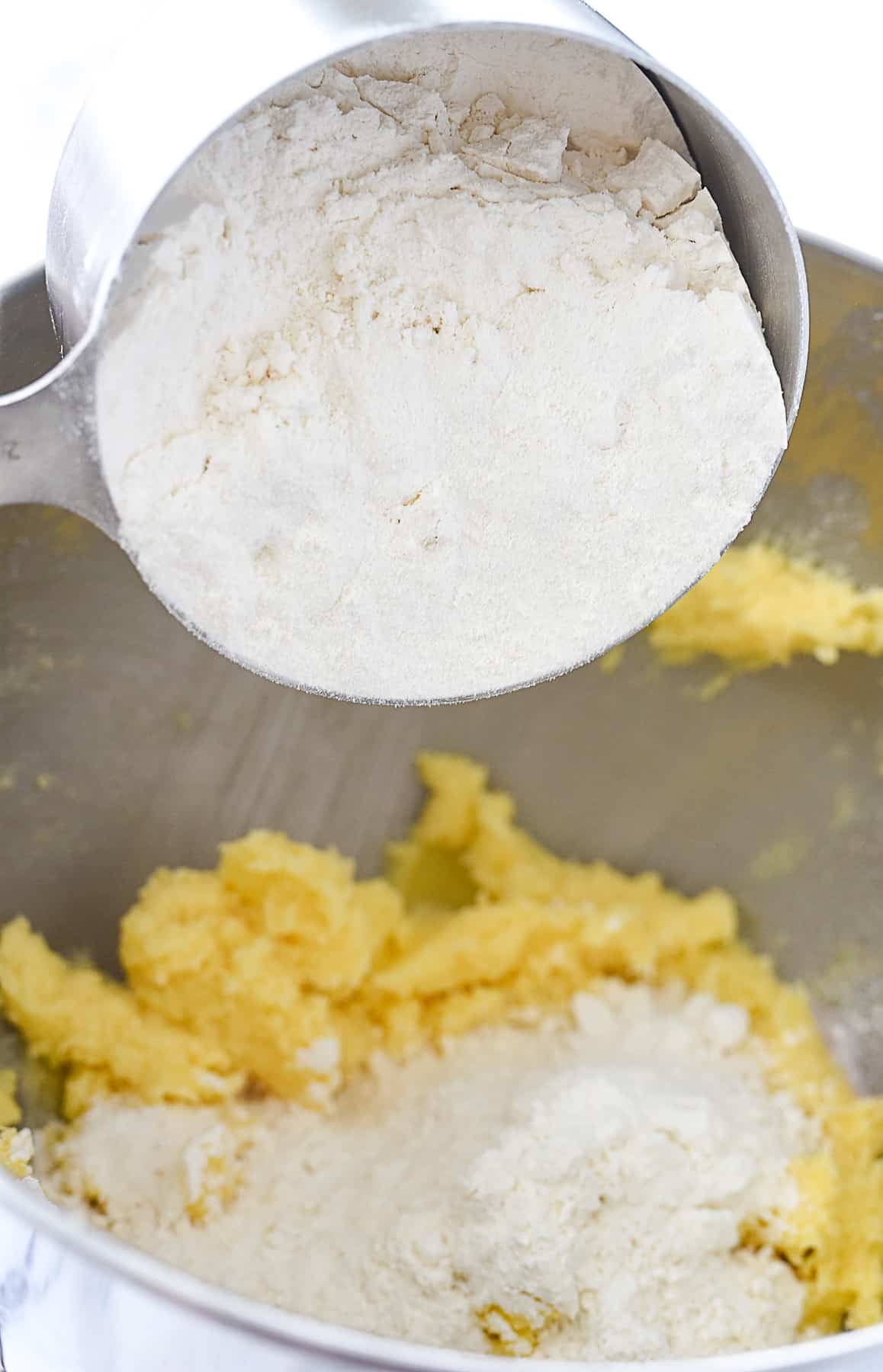 adding flour to cookie dough