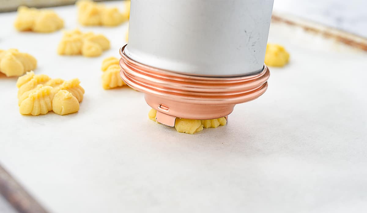 pressing cookie through cookie press