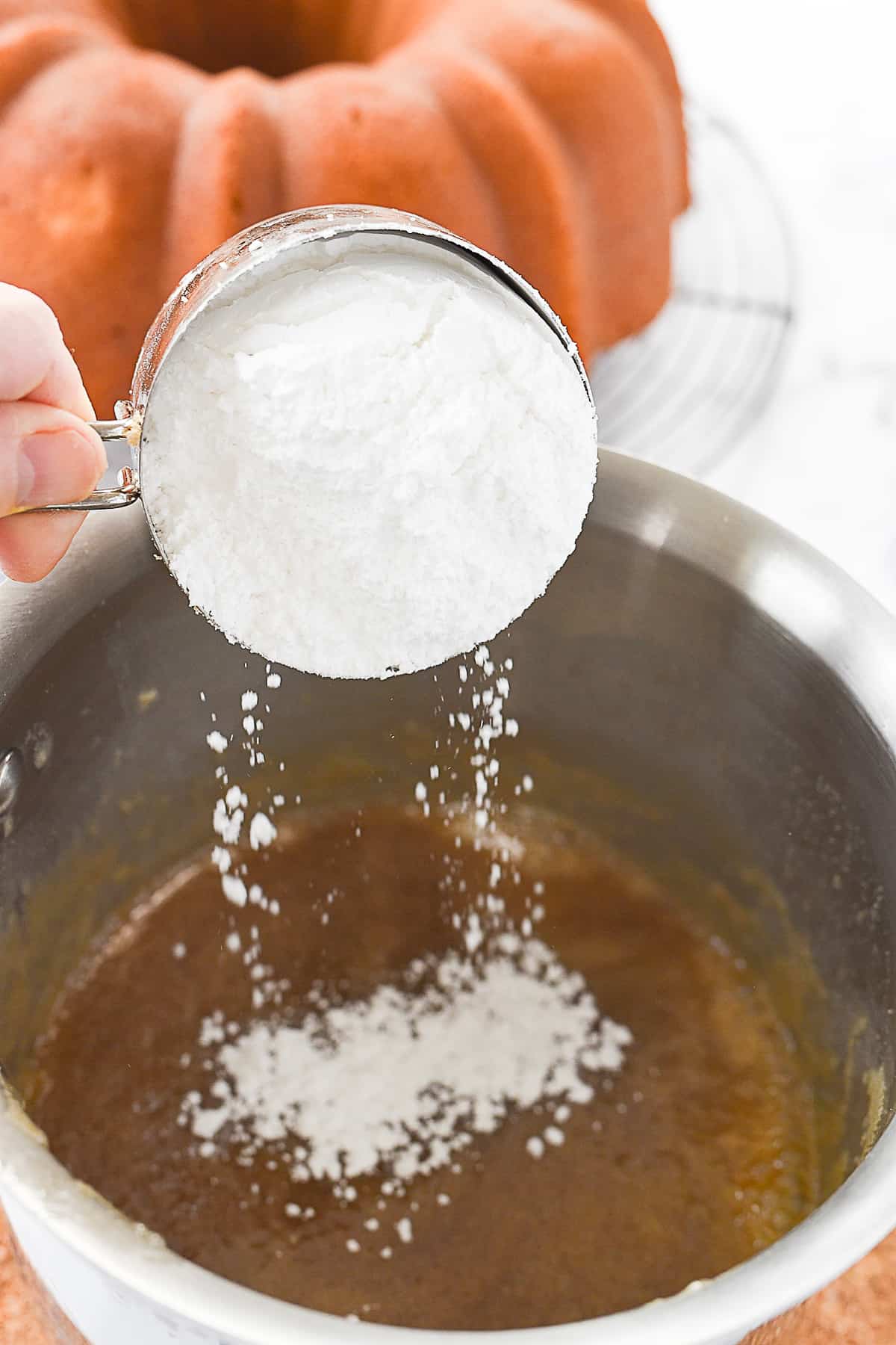 adding powdered sugar to butter