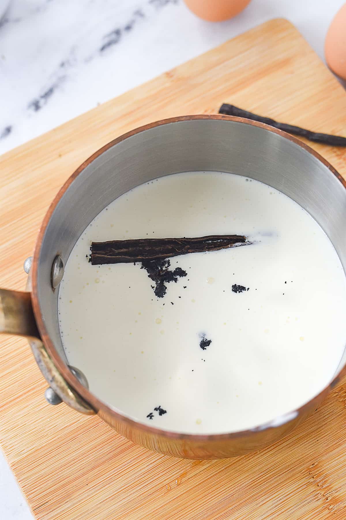 milk and vanilla bean in a pan