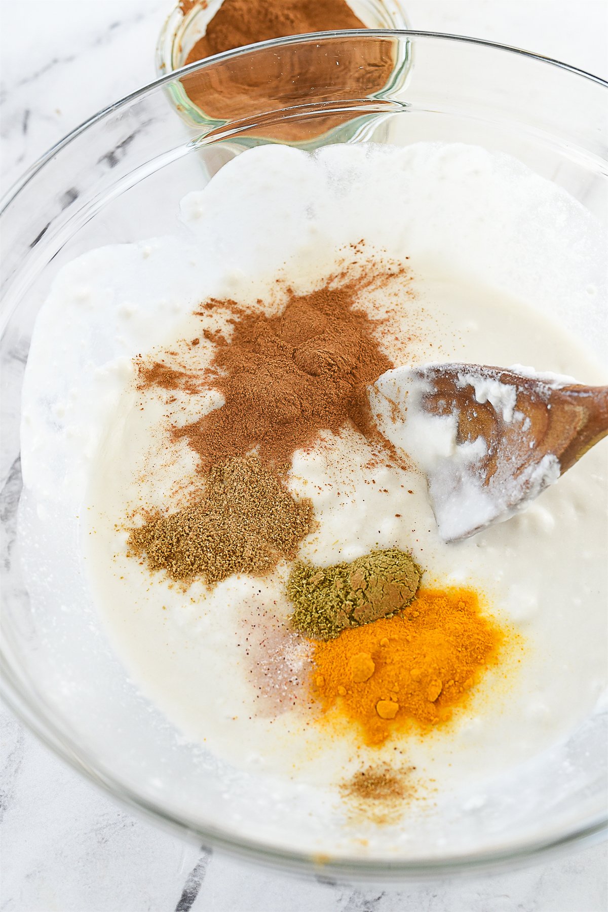 adding spices to coconut cream