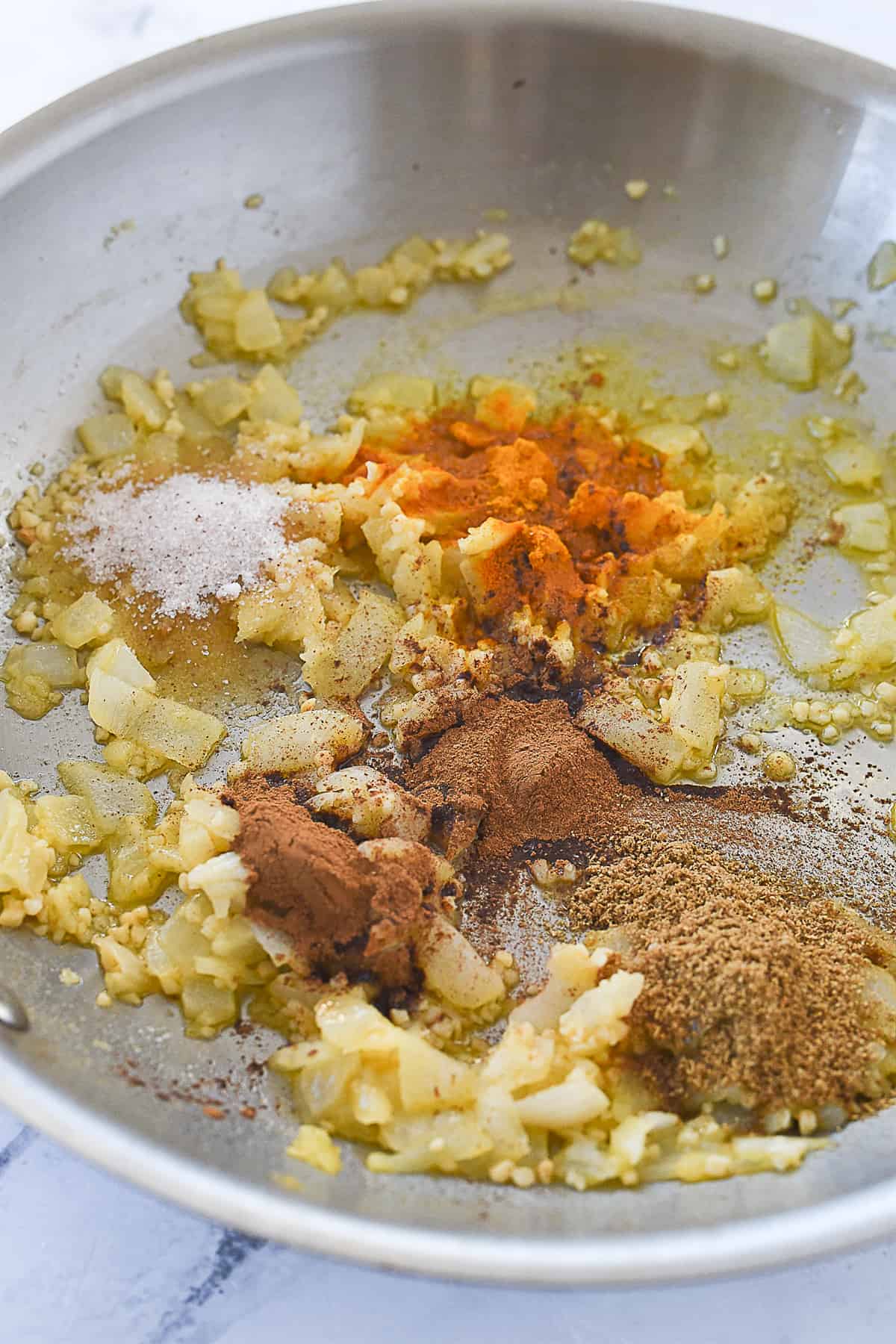 adding spices to onions