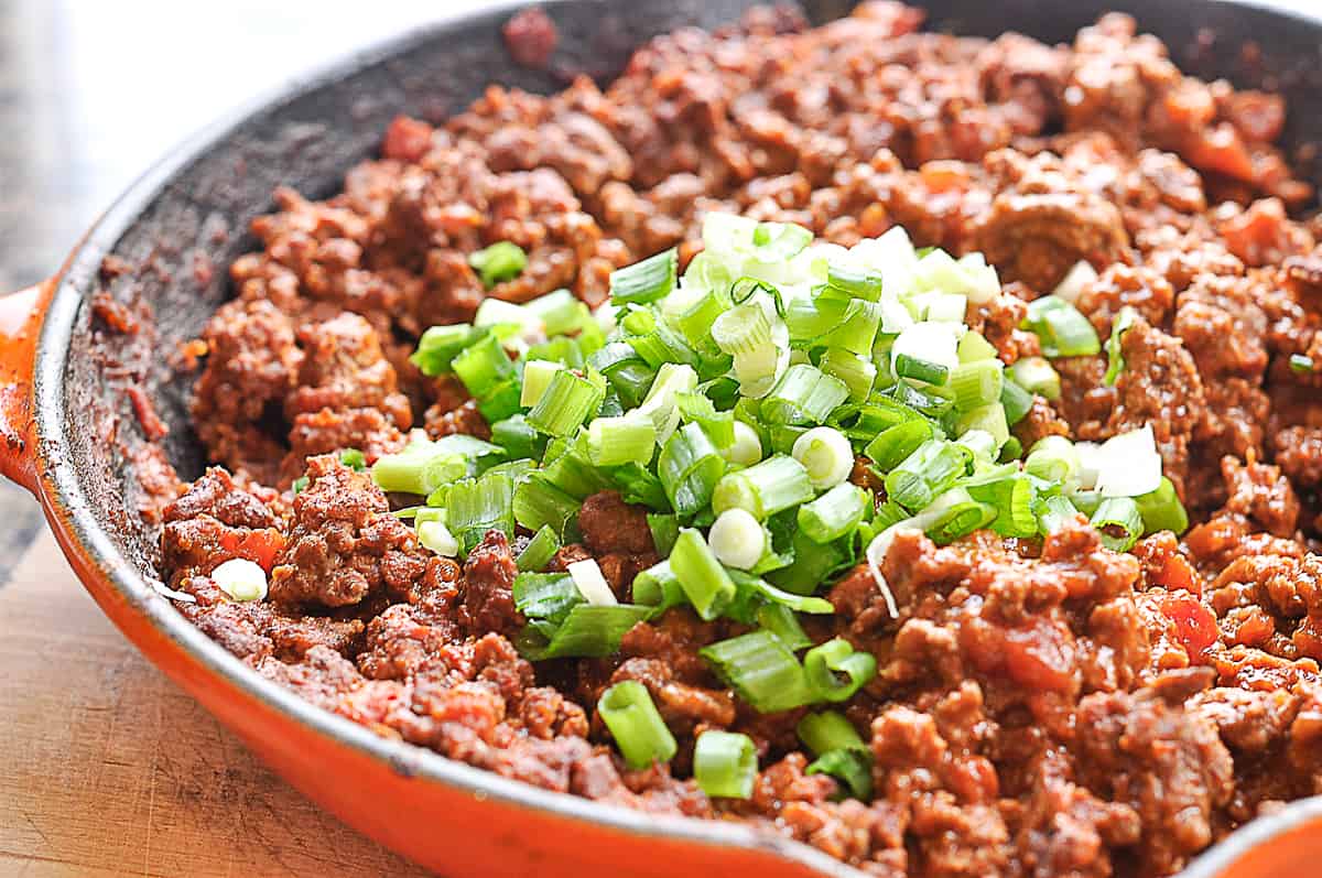 adding green onions to meat mixture