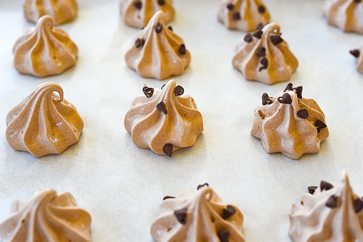 chocolate meringues on a cookie sheet