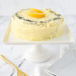 small lemon poppyseed cake on cake stand