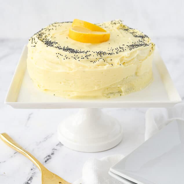 small lemon poppyseed cake on cake stand