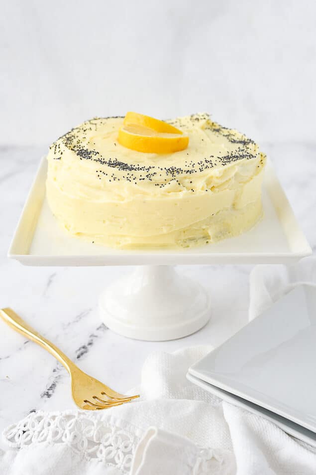 small lemon poppyseed cake on cake stand
