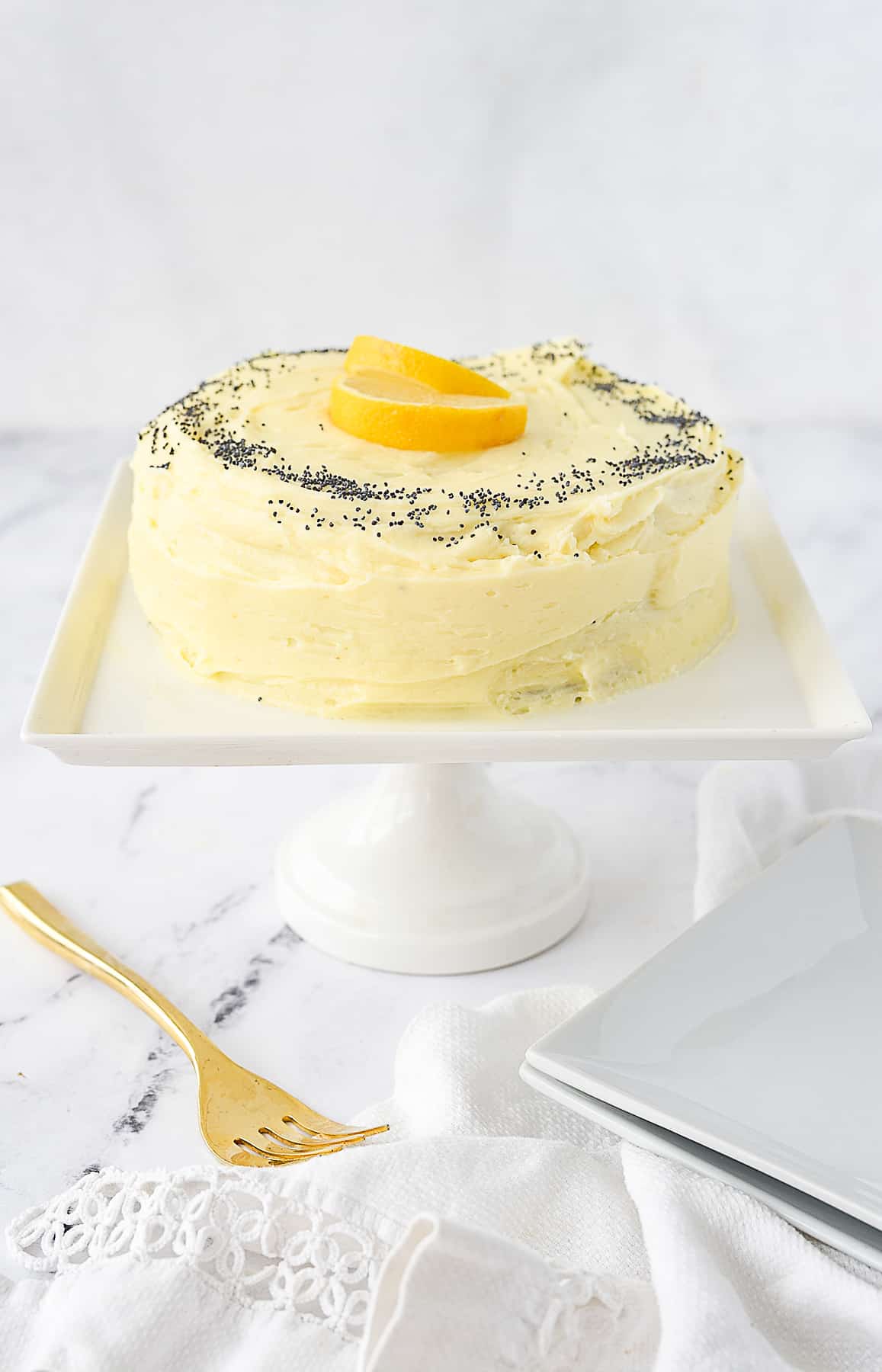 small lemon poppyseed cake on cake stand