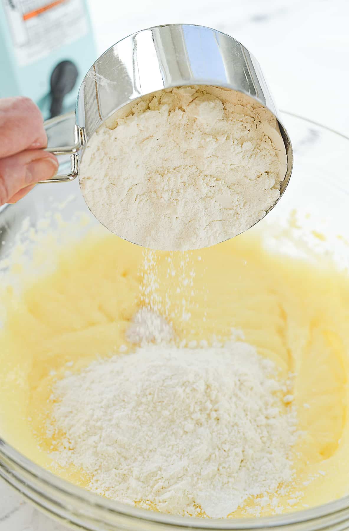 adding flour to cake batter