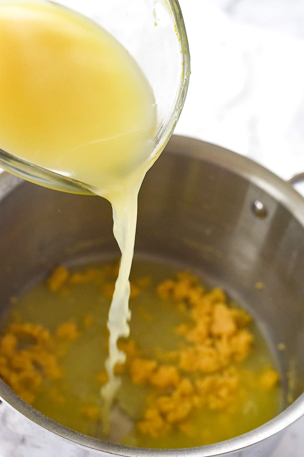 adding chicken broth to roux