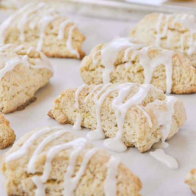 glazed lemon scones on a baking sheet