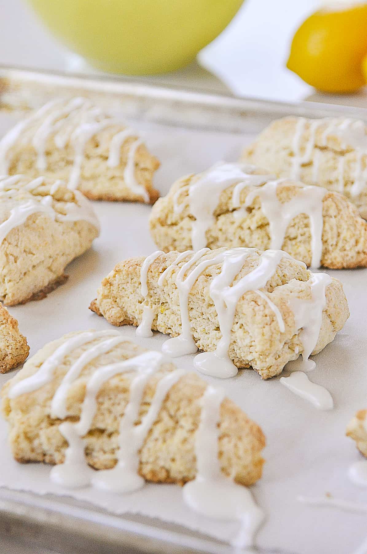 glazed lemon scones on a baking sheet