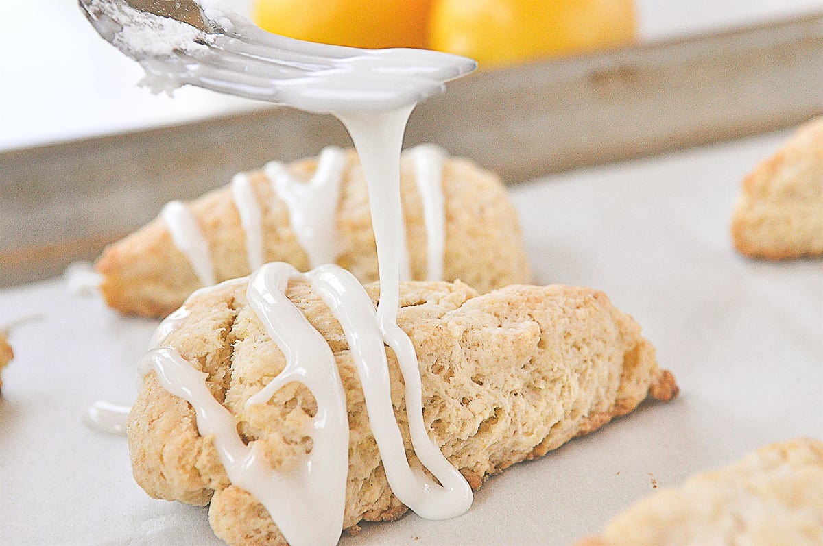 drizzling glaze on a lemon scone