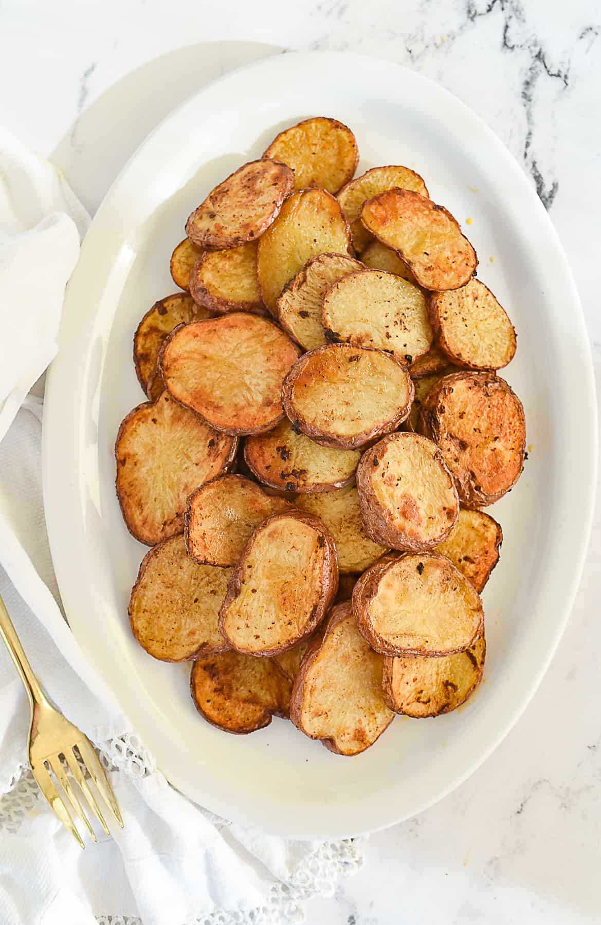 overhead shot of spicy potatoes on a plate