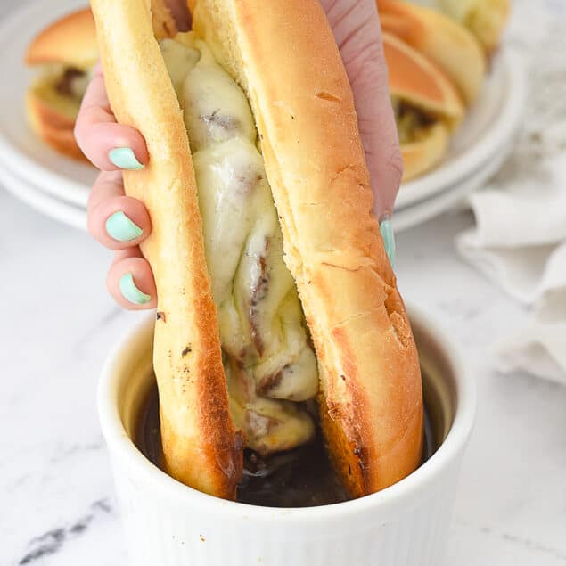 hand holding a french dip sandwich