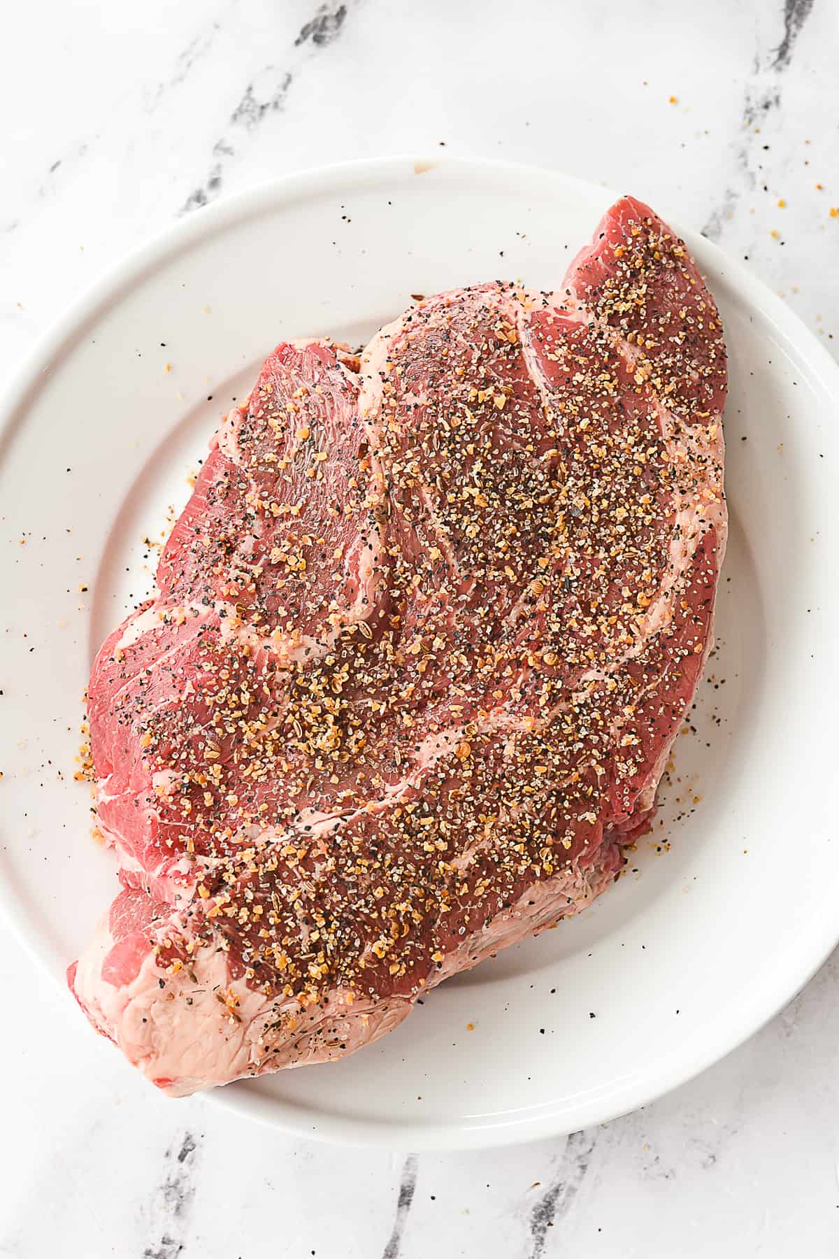 pot roast with salt and pepper on it
