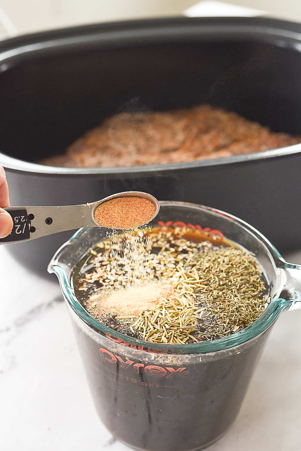 mixing together beef broth and spices