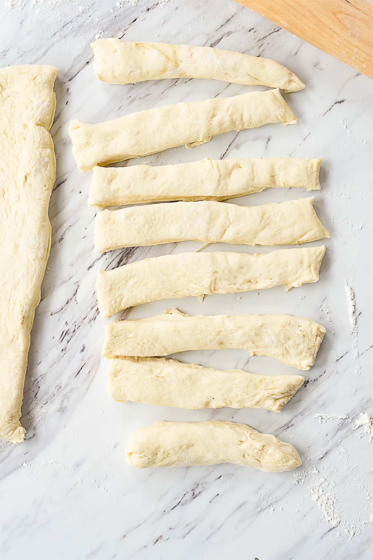 garlic knot dough cut into strips