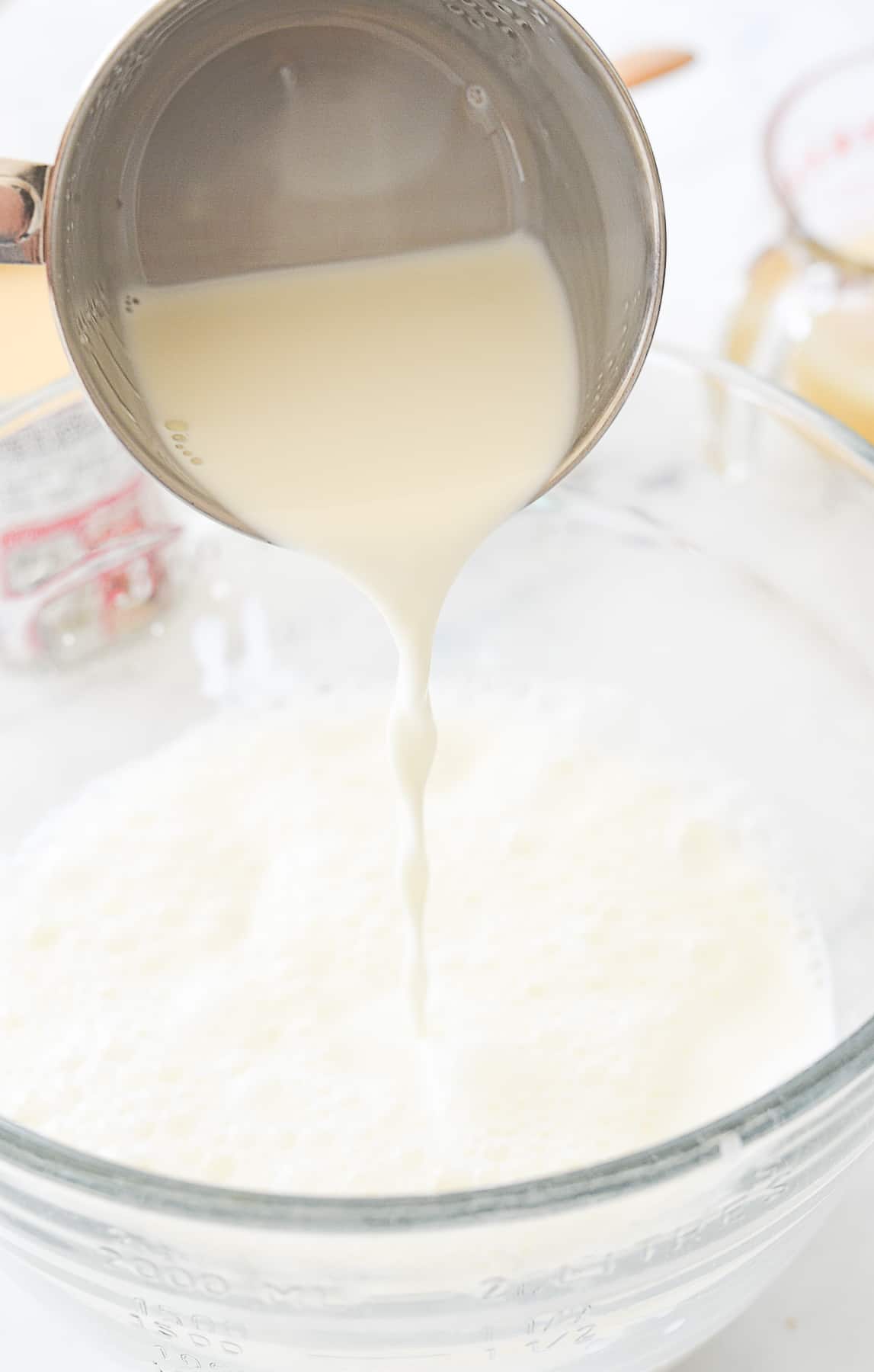 pouring milk into ice cream mixture