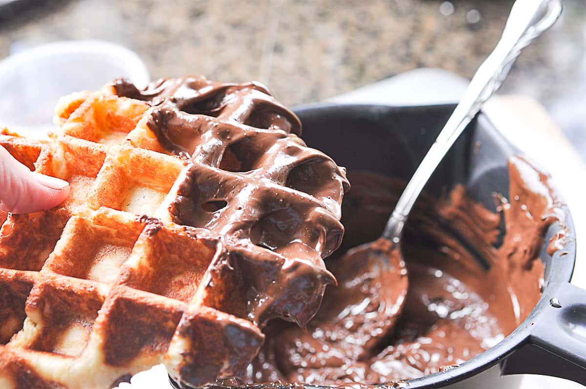 dipping a liege waffle in chocolate