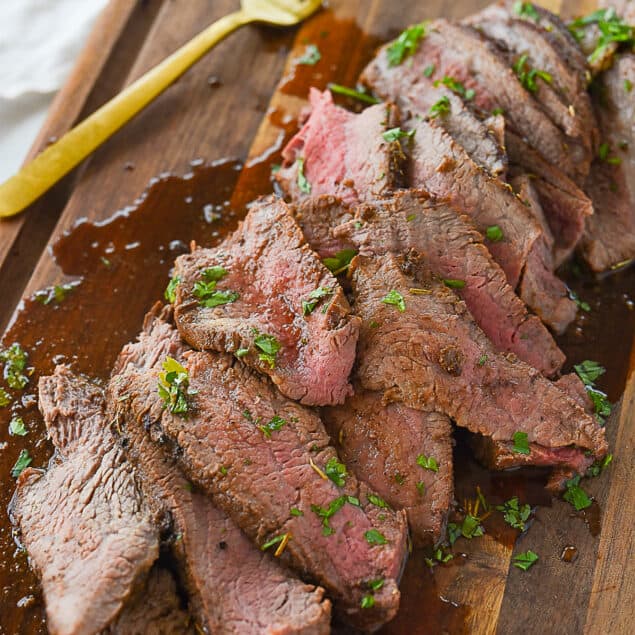 sliced tri tip with parsley on it.