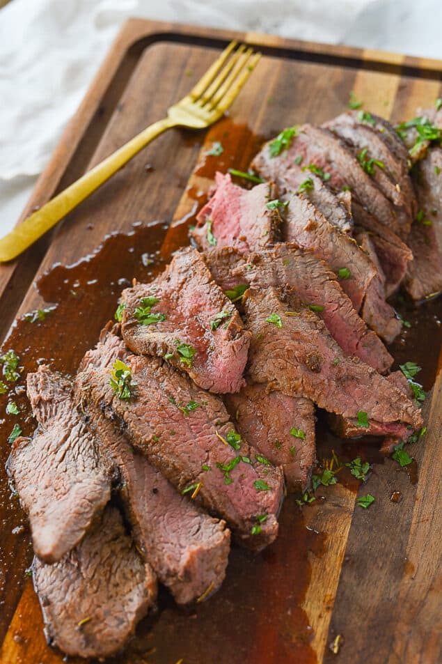 sliced tri tip with parsley on it.
