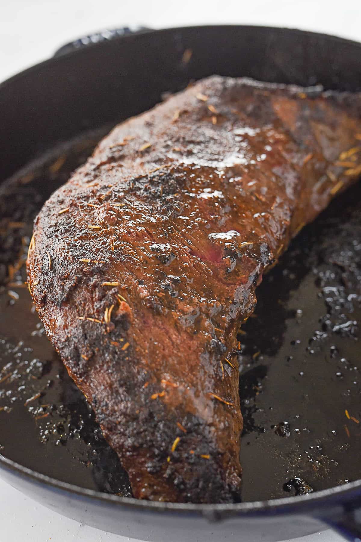 cooked tri tip in a cast iron pan