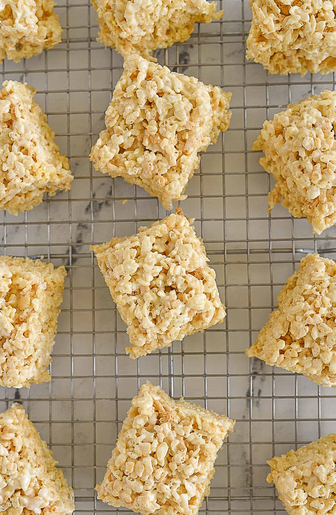 overhead shot of rice krispie treats on a cooling rack.