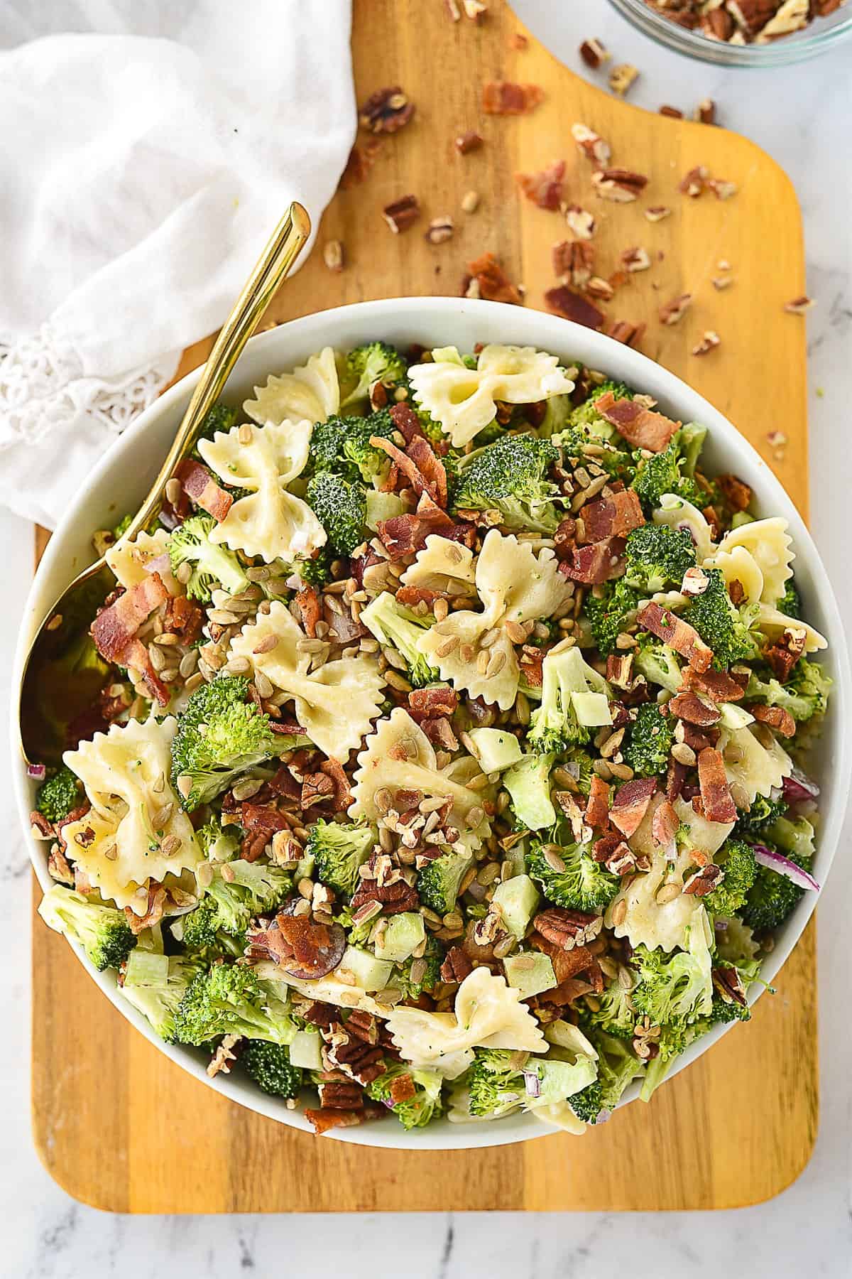 overhead shot of broccoli pasta salad in white bowl