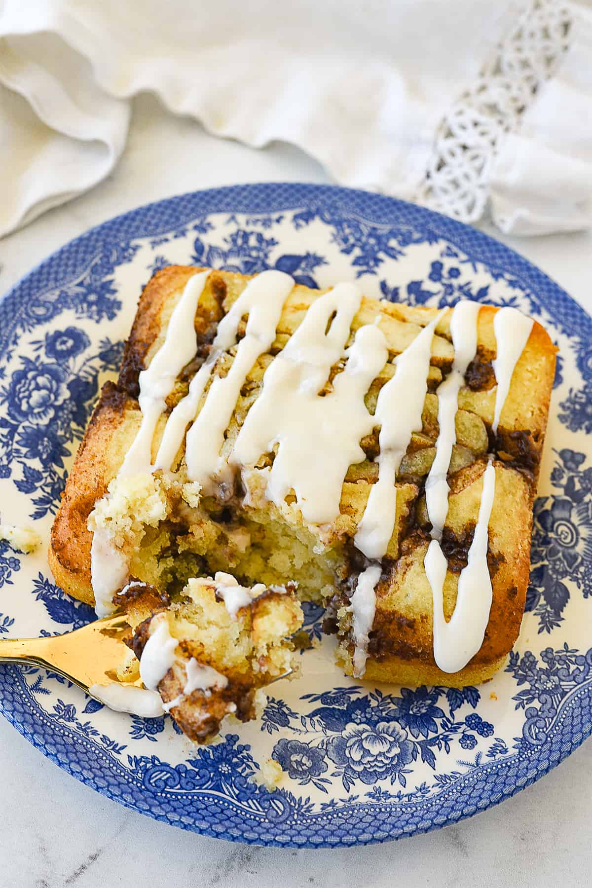 cinnamon swirk cake with a bite out of it