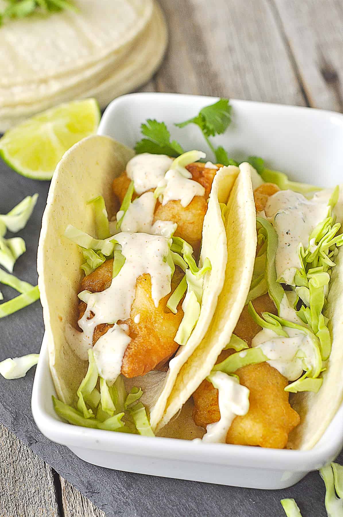 fish tacos with sauce on them